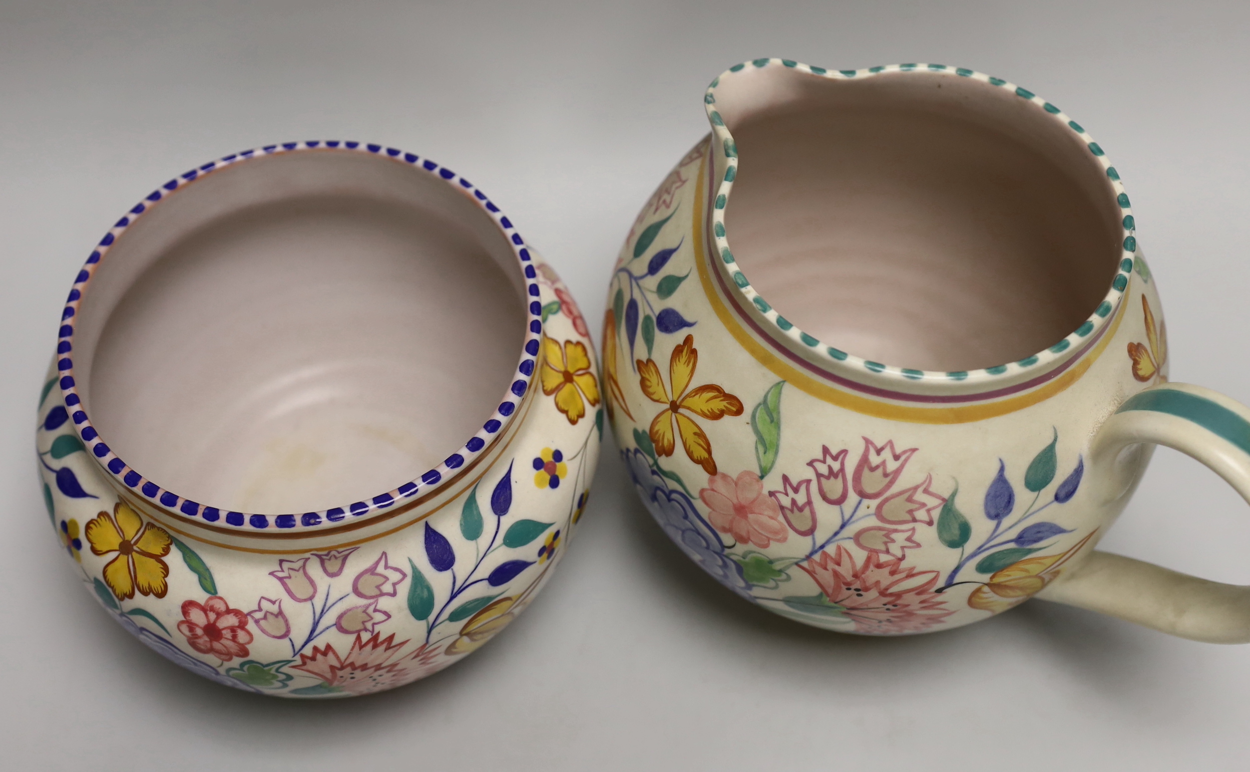 A Poole pottery tulip floral vase and jug and an hors d'oeuvre dish